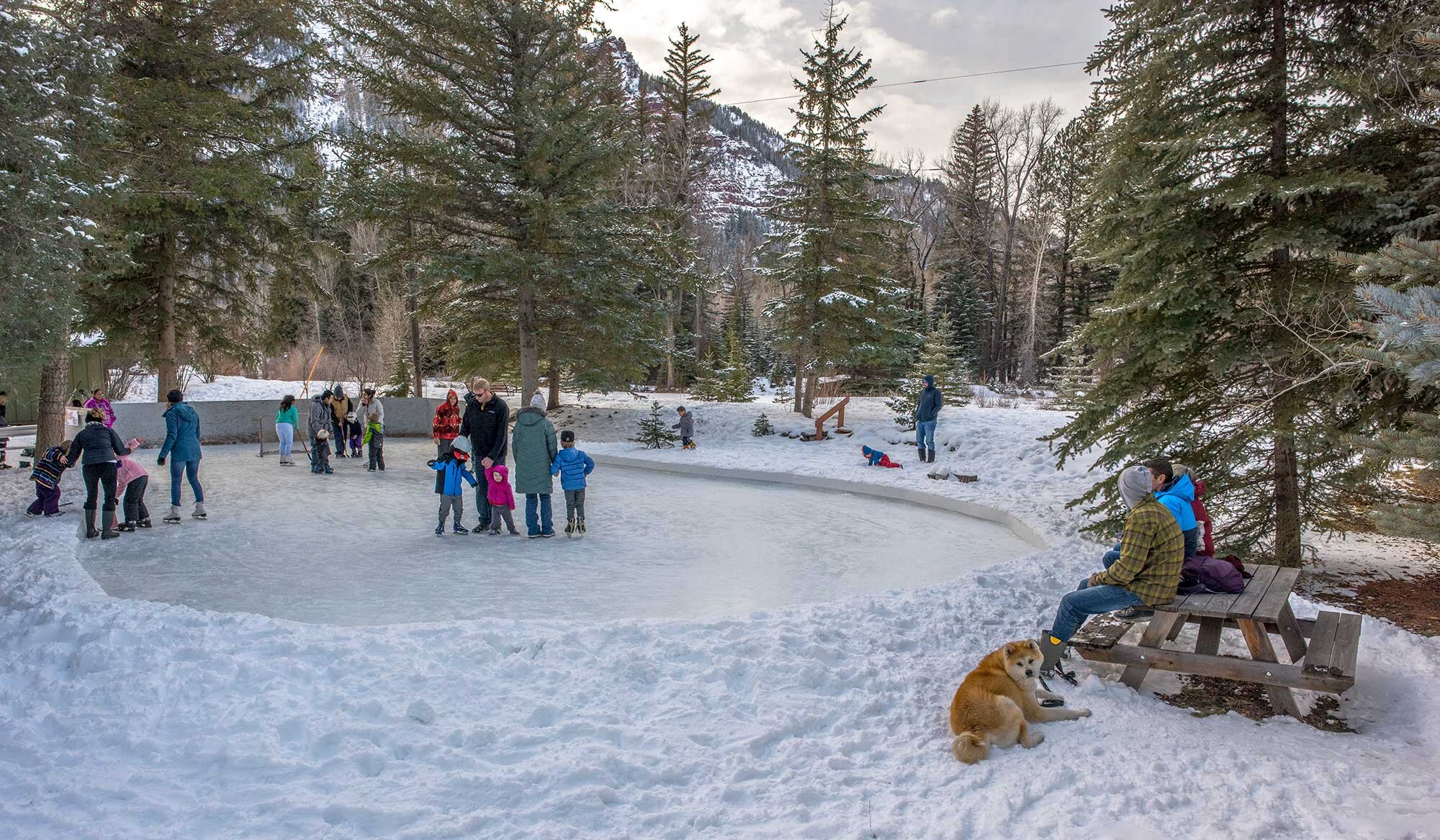 Young and Old ice skating on the free public skating rink in the Redstone Park